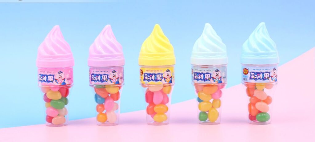 A colorful display of five ice cream cone-shaped containers filled with vibrant jelly beans, presented against a pastel pink and blue background. Produced by Tianfeng, this fun and creative packaging combines jelly beans and toy candy, making it a delightful treat for kids and candy lovers alike.